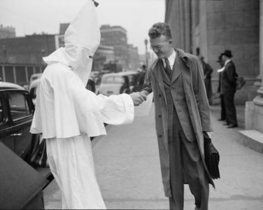 Ku_Klux_Klan_member_distributing_leaflets_in_Atlanta.jpeg.jpg